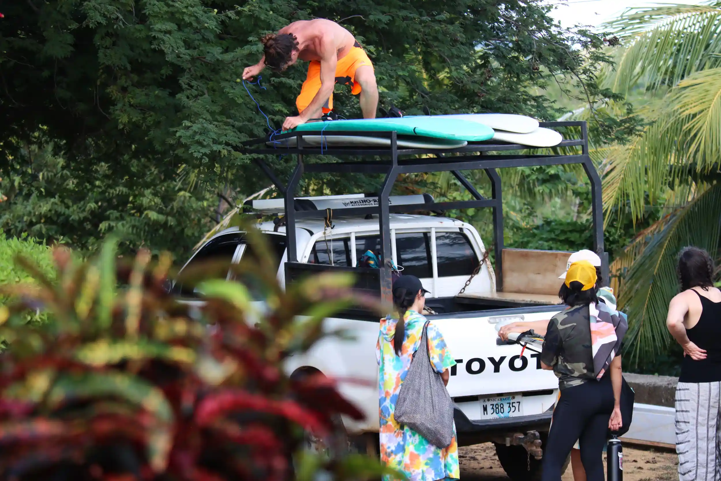 Surfers loading boards onto a truck near La Jolla de Guasacate.